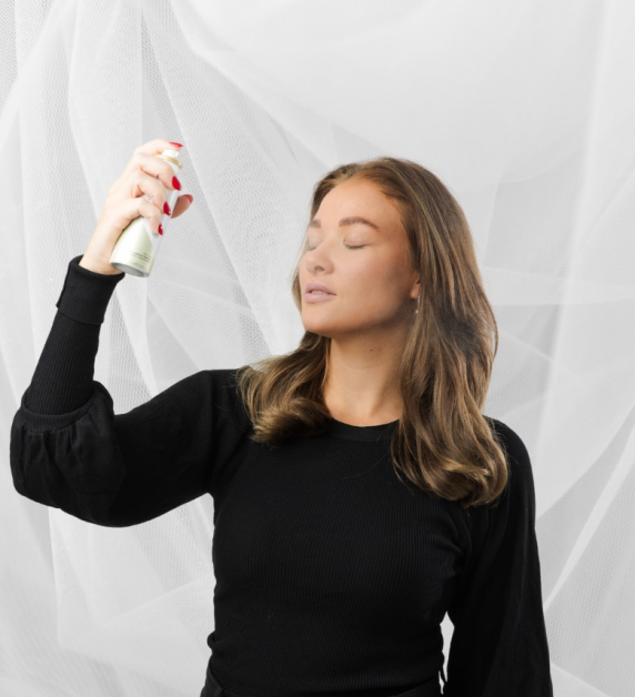 A picture of Glowhaven founder holding a skin mist