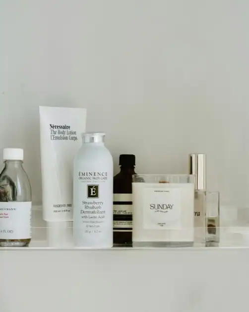 Body skincare products with actives on bathroom shelf