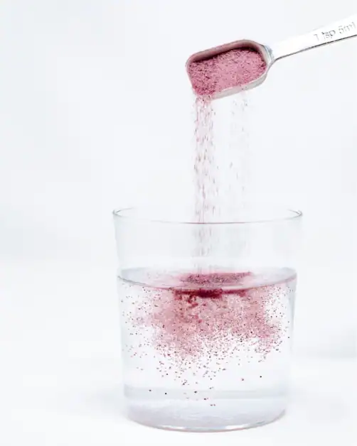 Collagen peptide powder being measured for daily supplement routine