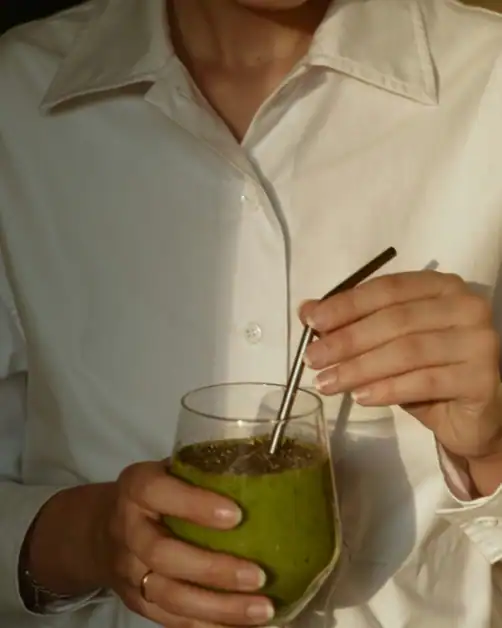 Woman drinking daily supplement smoothie for skin health