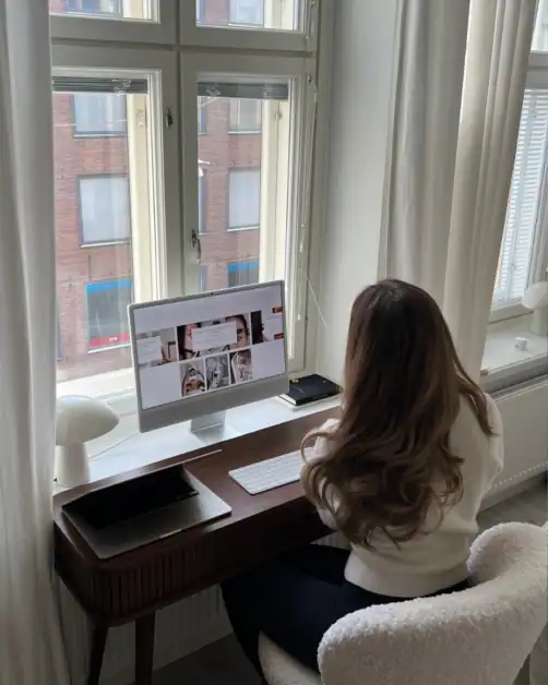 Working on Glowhaven blog at a desk by the window