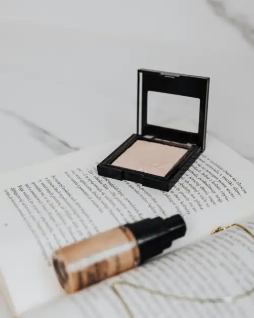 inspirational picture of setting powder and foundation flatlay on a book
