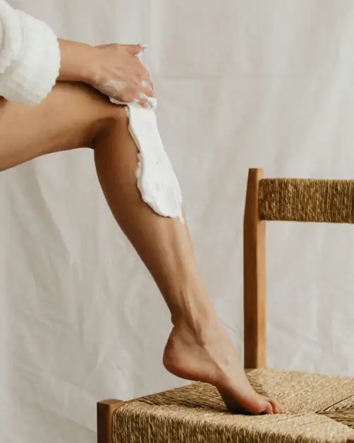 Close-up of body lotion being applied to skin as a daily moisturizing wellness habit